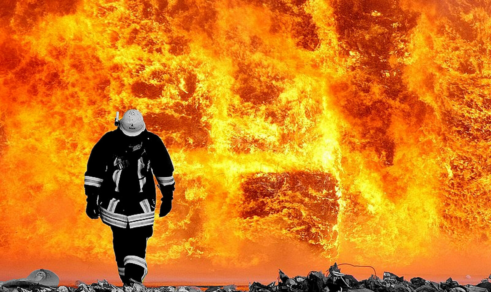 PPE certification: fire fighter walking trough fire