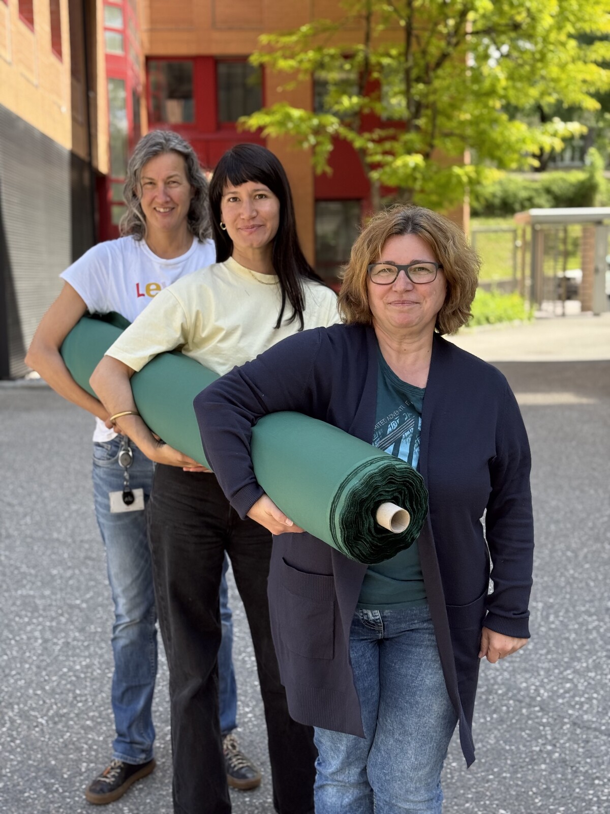 Eva Werilli, Process Developer Finishing at Getzner Textil, pictured in front with Barbara Paul and Andrea Breuker – together they’re presenting the green shirting fabric called “Scout.”